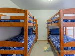 Double bunk beds are upstairs and next to the queen room.